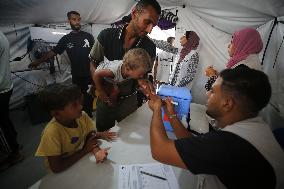 Palestinian Child Receives Polio Vaccination at UK-MED Field Hospital in Khan Younis Amid Conflict