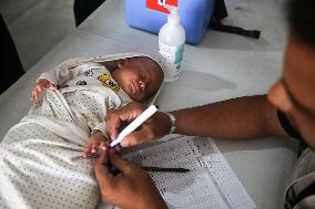 Palestinian Child Receives Polio Vaccination at UK-MED Field Hospital in Khan Younis Amid Conflict