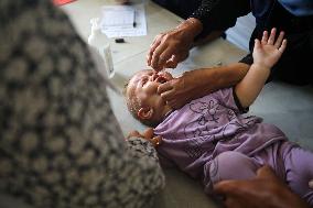 Palestinian Child Receives Polio Vaccination at UK-MED Field Hospital in Khan Younis Amid Conflict