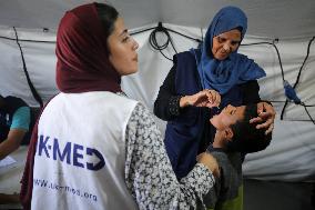 Palestinian Child Receives Polio Vaccination at UK-MED Field Hospital in Khan Younis Amid Conflict