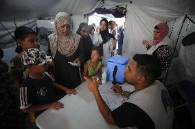 Palestinian Child Receives Polio Vaccination at UK-MED Field Hospital in Khan Younis Amid Conflict