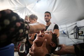 Palestinian Child Receives Polio Vaccination at UK-MED Field Hospital in Khan Younis Amid Conflict