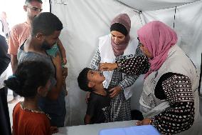 Palestinian Child Receives Polio Vaccination at UK-MED Field Hospital in Khan Younis Amid Conflict