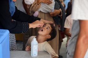 Palestinian Child Receives Polio Vaccination at UK-MED Field Hospital in Khan Younis Amid Conflict