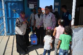 Palestinian Child Receives Polio Vaccination at UK-MED Field Hospital in Khan Younis Amid Conflict