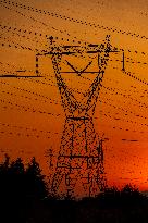 High Voltage Pylons During Sunset Time