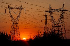 High Voltage Pylons During Sunset Time