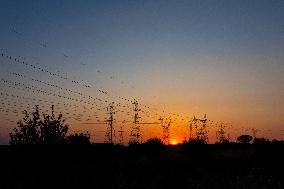 High Voltage Pylons During Sunset Time