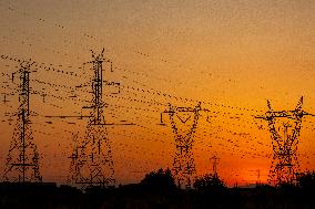 High Voltage Pylons During Sunset Time