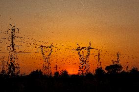 High Voltage Pylons During Sunset Time