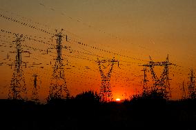 High Voltage Pylons During Sunset Time