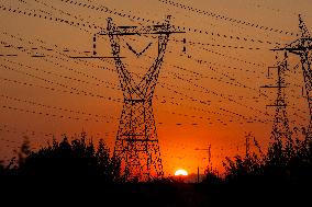 High Voltage Pylons During Sunset Time