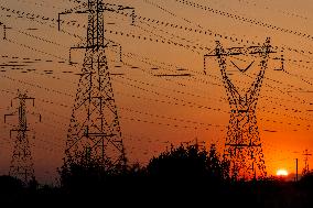 High Voltage Pylons During Sunset Time