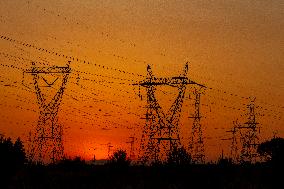 High Voltage Pylons During Sunset Time