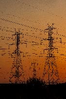 High Voltage Pylons During Sunset Time