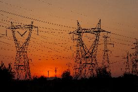 High Voltage Pylons During Sunset Time