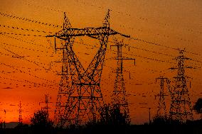 High Voltage Pylons During Sunset Time