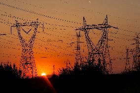 High Voltage Pylons During Sunset Time