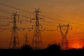 High Voltage Pylons During Sunset Time