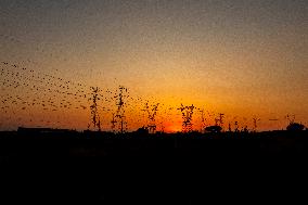 High Voltage Pylons During Sunset Time