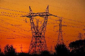 High Voltage Pylons During Sunset Time