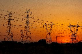 High Voltage Pylons During Sunset Time