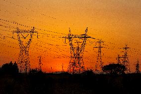 High Voltage Pylons During Sunset Time