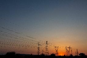 High Voltage Pylons During Sunset Time