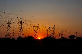 High Voltage Pylons During Sunset Time