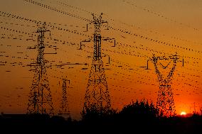 High Voltage Pylons During Sunset Time