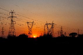 High Voltage Pylons During Sunset Time