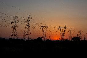 High Voltage Pylons During Sunset Time