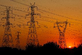 High Voltage Pylons During Sunset Time