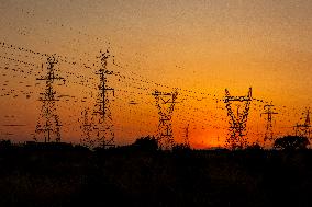 High Voltage Pylons During Sunset Time