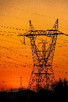 High Voltage Pylons During Sunset Time