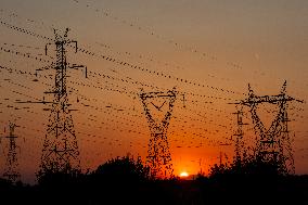 High Voltage Pylons During Sunset Time