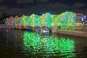 Rainbow Bridge and Ferris Wheel Night View in Qingdao