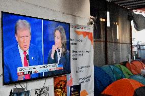 2024 US Presidential Election: Migrants Watch First Debate Harris/Trump In Tijuana, Mexico Shelter