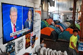 2024 US Presidential Election: Migrants Watch First Debate Harris/Trump In Tijuana, Mexico Shelter