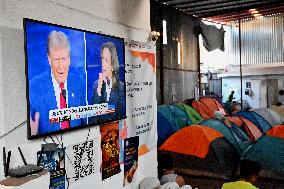 2024 US Presidential Election: Migrants Watch First Debate Harris/Trump In Tijuana, Mexico Shelter