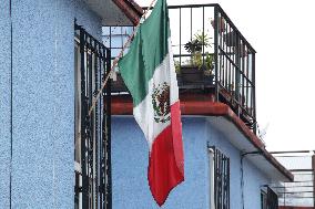 Mexican Flag Hanging In A Window