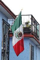 Mexican Flag Hanging In A Window