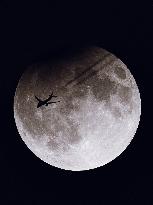 TAP Air Portugal Flight Passes In Front Of Partially Eclipsed Super Moon During Rare Celestial Event