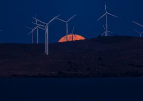 A Supermoon Rises Above The Wind Turbines - Australia