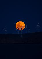 A Supermoon Rises Above The Wind Turbines - Australia