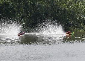 Rider Compete During The Annual ''Sword-Headed Boat Racing Festival