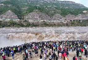 Tourists Visit The Hukou Waterfall - China