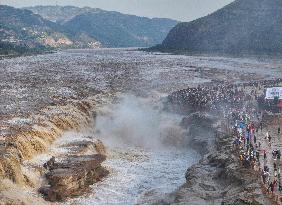 Tourists Visit The Hukou Waterfall - China