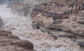 Tourists Visit The Hukou Waterfall - China