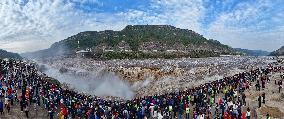 Tourists Visit The Hukou Waterfall - China